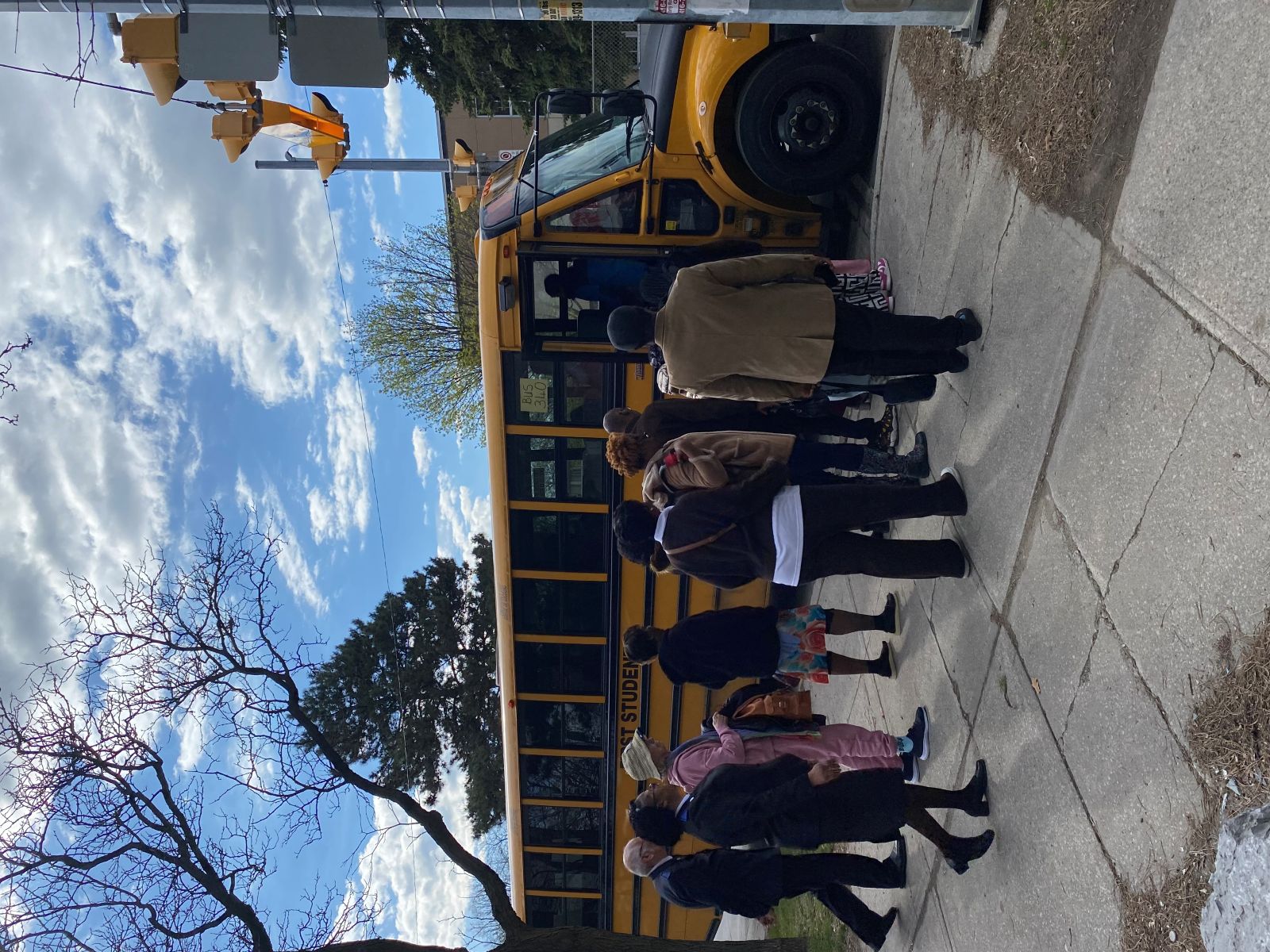 people getting on a school bus