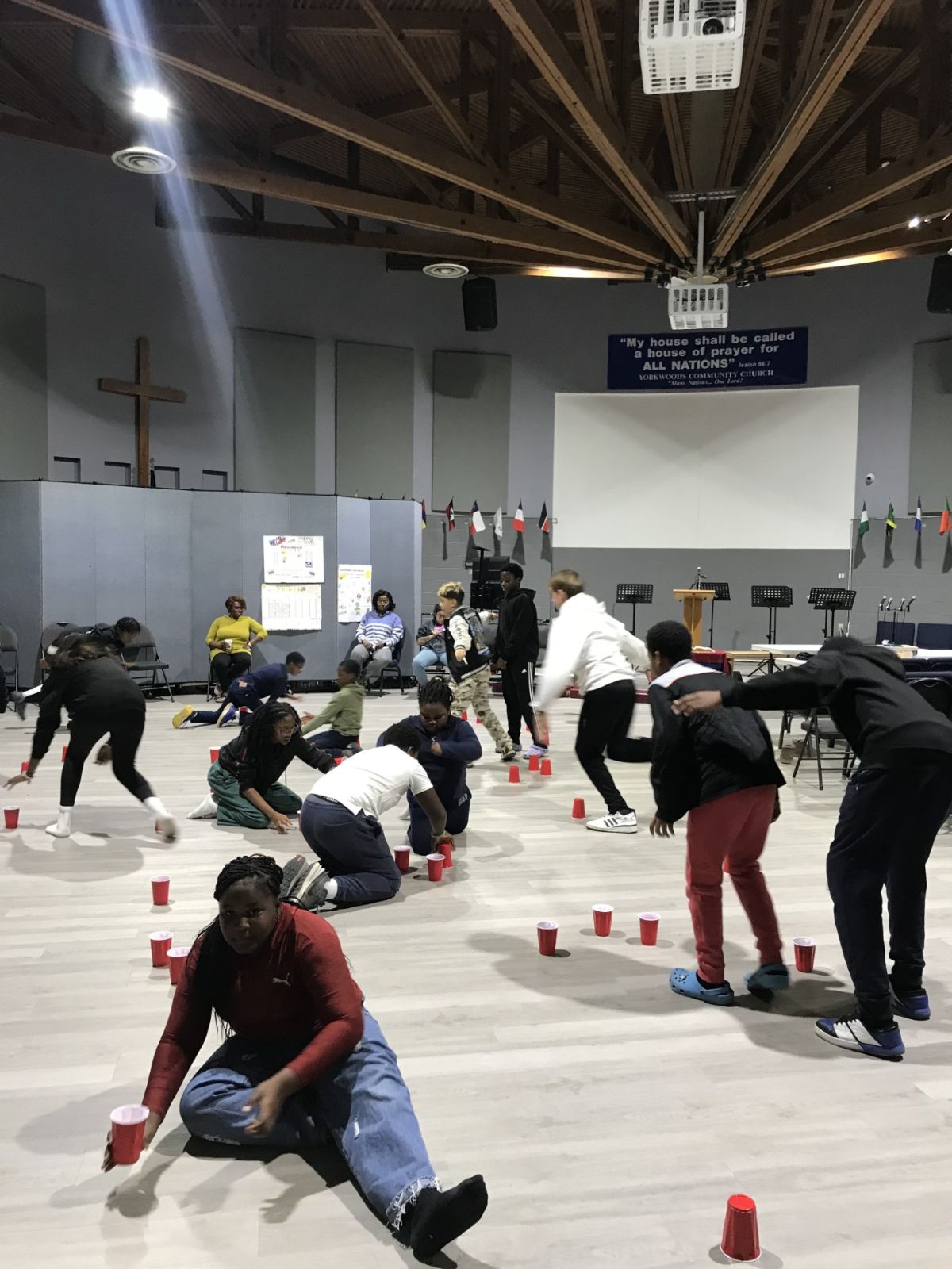 group of young people playing a game in a large space