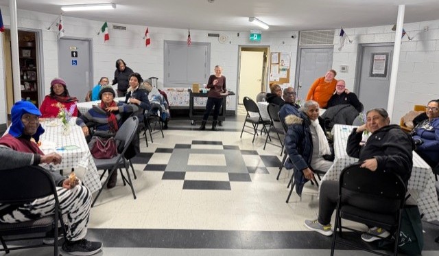people sitting around several tables having conversations